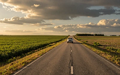 Rural road through farmland - long-distance relationships in the country
